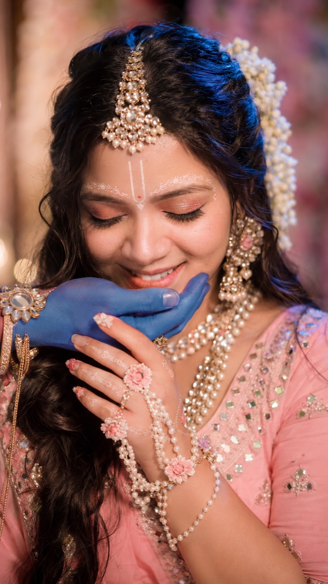 Radha–Janmashtami portrait with Krishna's blue hand at the chin